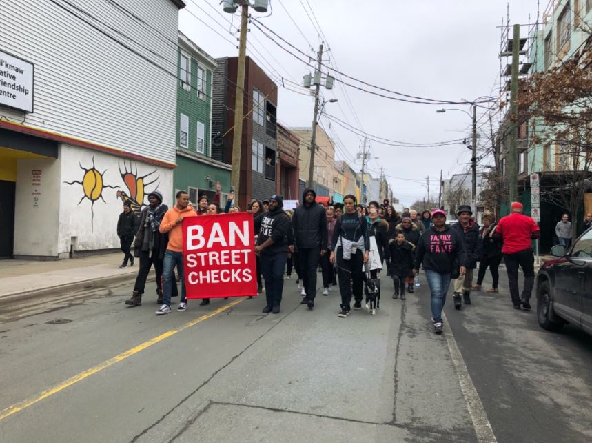 Protesters walked down Gottingen Street on Saturday, March 30, 2019, calling for the end of street checks in Halifax.