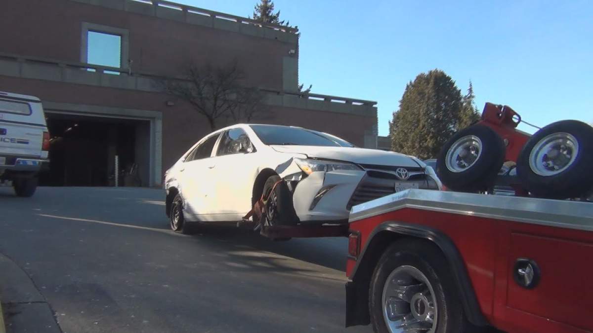 The suspect vehicle in Monday\’s hit and run is towed to a police facility.