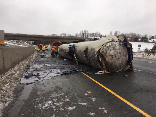 A tank trailer rolled over and spilled tar across part of the highway.