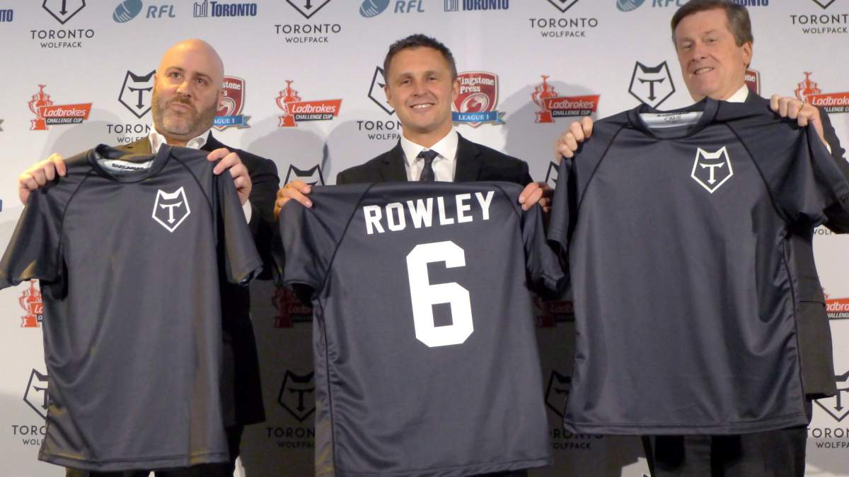 Eric Perez, the founder and CEO of the Toronto Wolfpack (left), Wolfpack head coach Paul Rowley and Toronto Mayor John Tory hold up jerseys of the new rugby league team in Toronto, Wednesday, April 27, 2016. Perez, who helped bring professional rugby league to North America in the form of the Toronto Wolfpack, now has an ownership stake in another club.