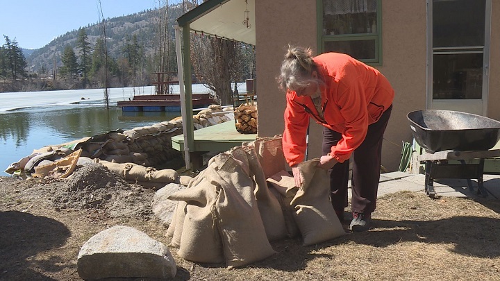 Sandra Hawthorne fills sandbags to protect her house from being flooded.