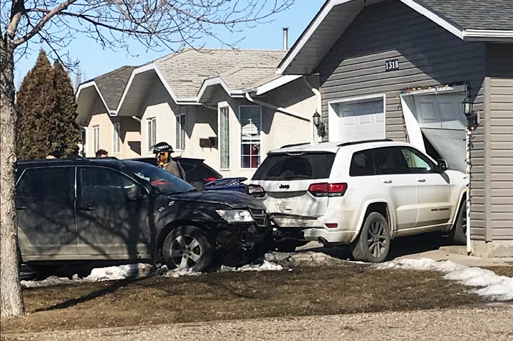 Saskatoon's fire department says a Dodge Journey struck a parked Jeep Grand Cherokee and subsequently collided with the garage door of a local house.