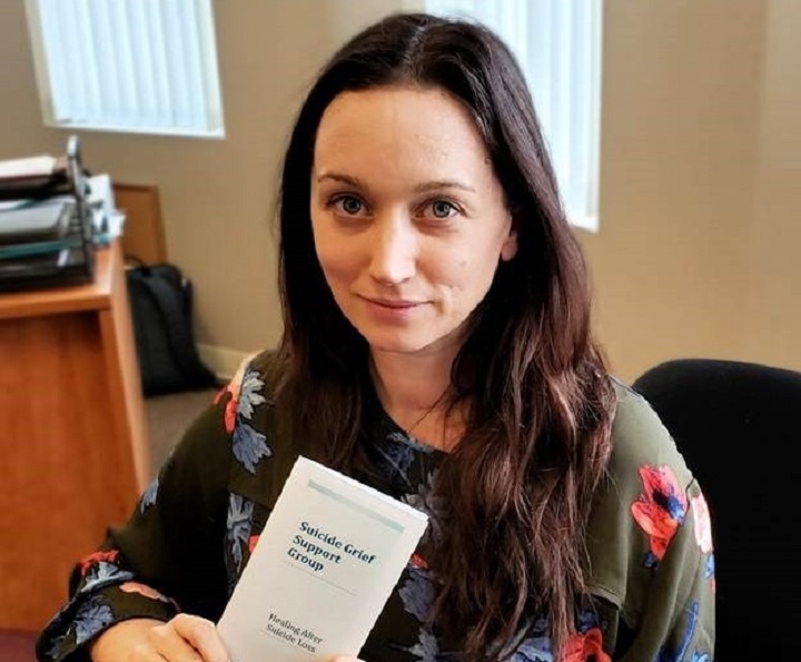 Julia Payson of the Vernon and District branch of the Canadian Mental Health Association holds a suicide grief support group pamphlet. The branch will be hosting free, support sessions for suicide grief starting March 20.