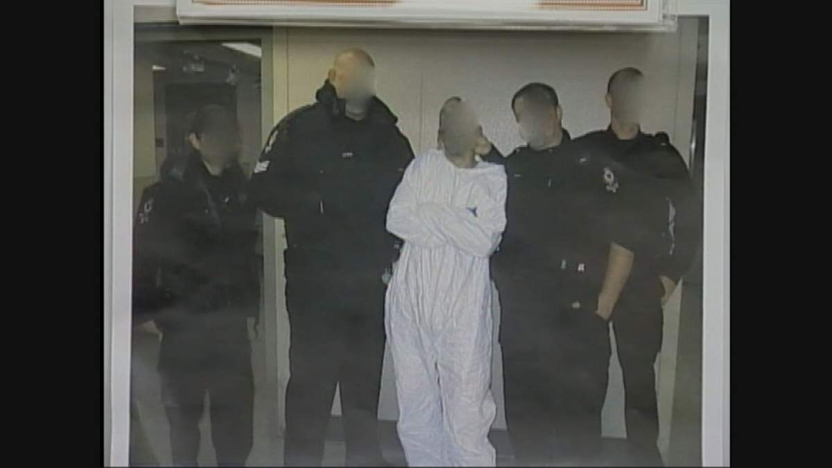 The notorious ‘trophy photo’ that Vancouver police officers took with Weigelt after his arrest.