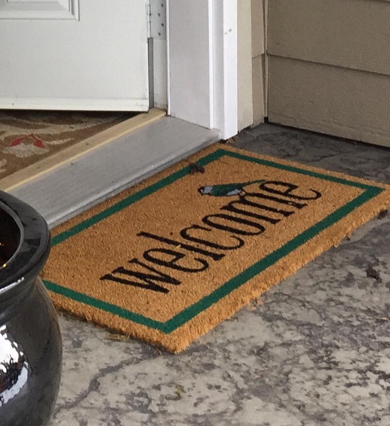 Welcome mat by door.