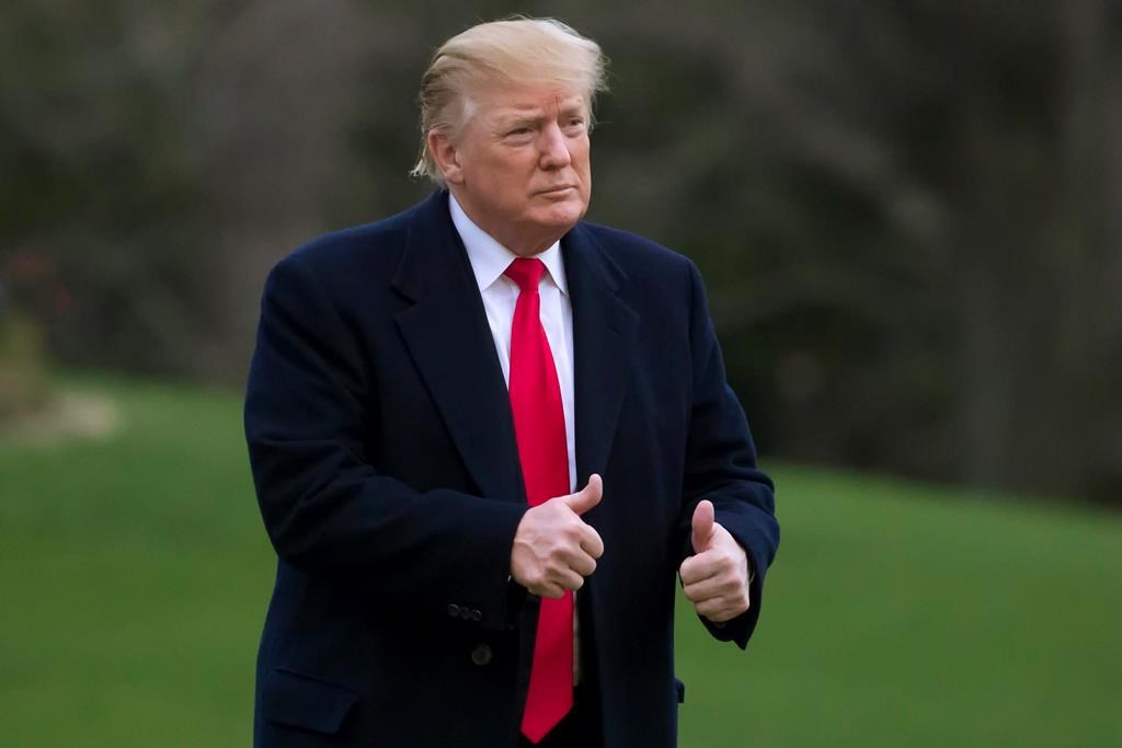 In this March 24, 2019, photo, President Donald Trump gives two thumbs up after stepping off Marine One on the South Lawn of the White House in Washington.