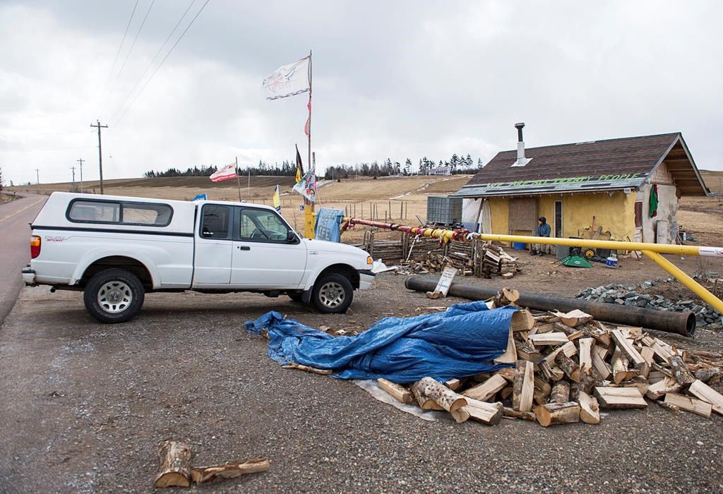 An unidentified man sits outside a Mi'kmaq camp at the entrance to an Alton Gas work site along the Shubenacadie River, in Fort Ellis, N.S. on Monday, March 18, 2019.