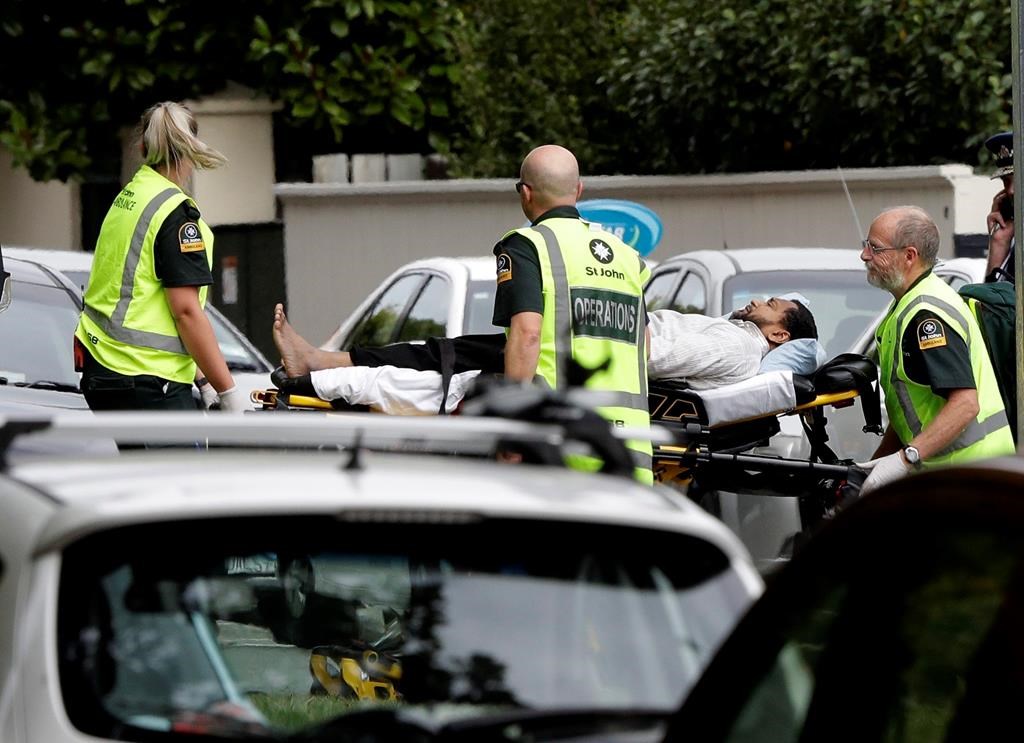 Ambulance staff take a man from outside a mosque in central Christchurch, New Zealand, Friday, March 15, 2019.