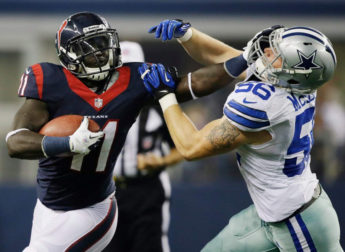 Houston Texan’s running back Cierre Wood, left, stiff-arms Dallas Cowboys linebacker Caleb McSurdy (56) during the first half of a preseason NFL football game on Thursday, Aug. 29, 2013, in Arlington, Texas.