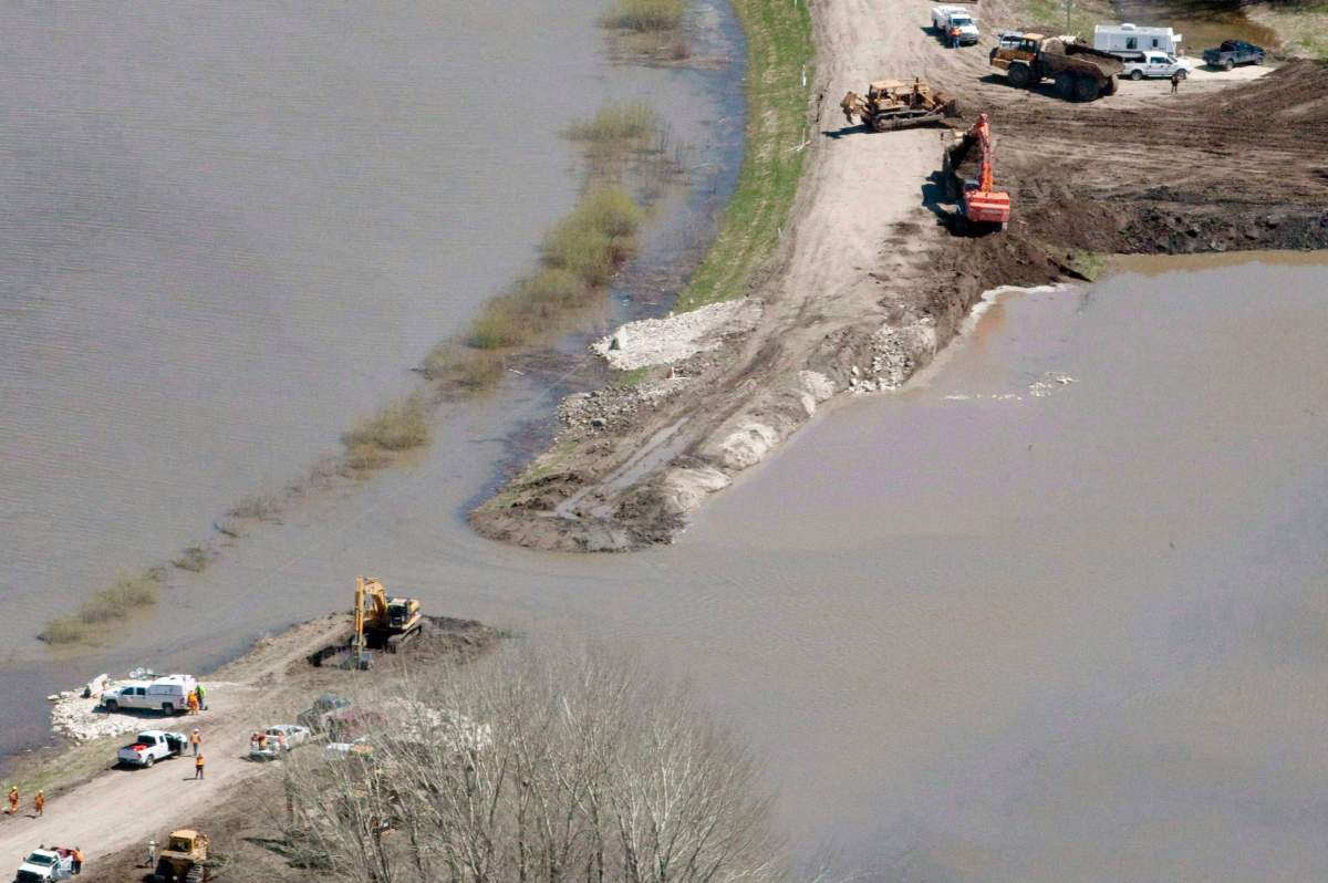 The breach in the dike at the hoop and holler bend is seen along the Assiniboine River outside of Portage La Prairie, Man., on Saturday, May 14, 2011.