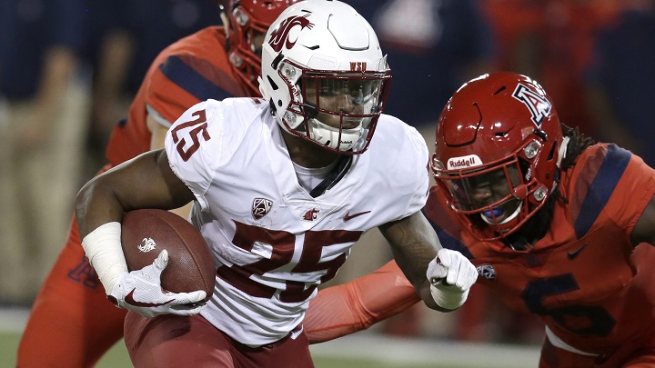 Washington State running back Jamal Morrow runs a way from the tackle of Arizona safety Demetrius Flannigan-Fowles in the first half during an NCAA college football game on Oct. 28, 2017.