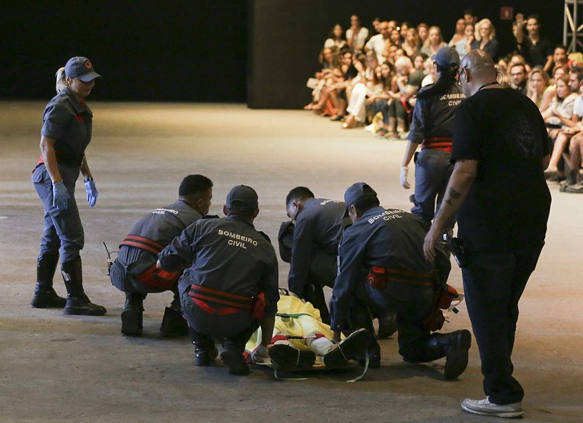 Model Tales Soares is taken from the catwalk by paramedics after he collapsed during Sao Paulo Fashion Week in Sao Paulo, Brazil, Saturday, April 27, 2019. A statement from organizers said that Soares died after taking ill while participating in Sao Paulo Fashion Week. (Leco Viana/Thenews2 via AP)