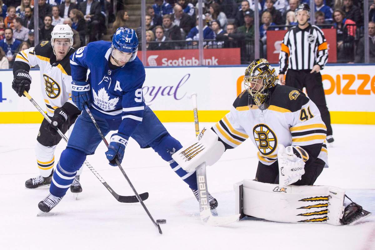 Toronto Maple Leafs' John Tavares (91)tries to steer the puck past Boston Bruins goaltender Jaroslav Halak during second period NHL hockey action in Toronto on Monday, Nov. 26, 2018.
