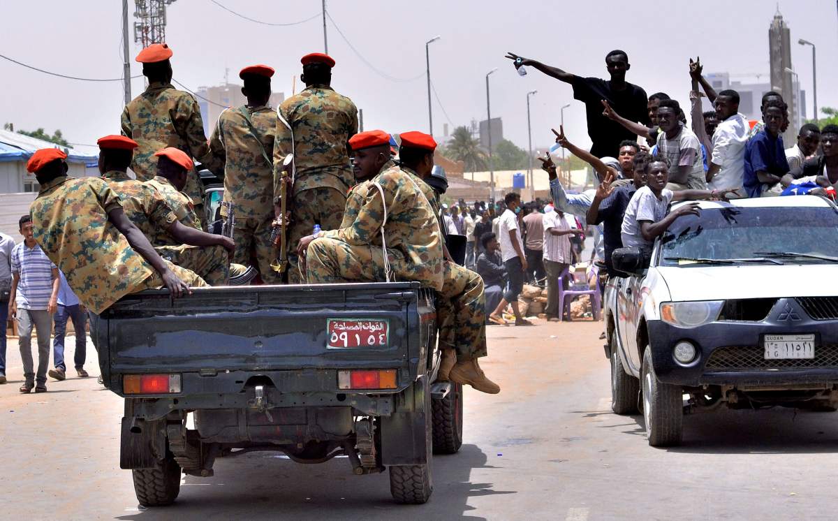 Sudanese demonstrators cheer as they drive towards a military vehicle, after Sudan’s Defense Minister Awad Mohamed Ahmed Ibn Auf said that President Omar al-Bashir had been detained “in a safe place” and that a military council would run the country for a two-year transitional period, near Defence Ministry in Khartoum, Sudan April 11, 2019.