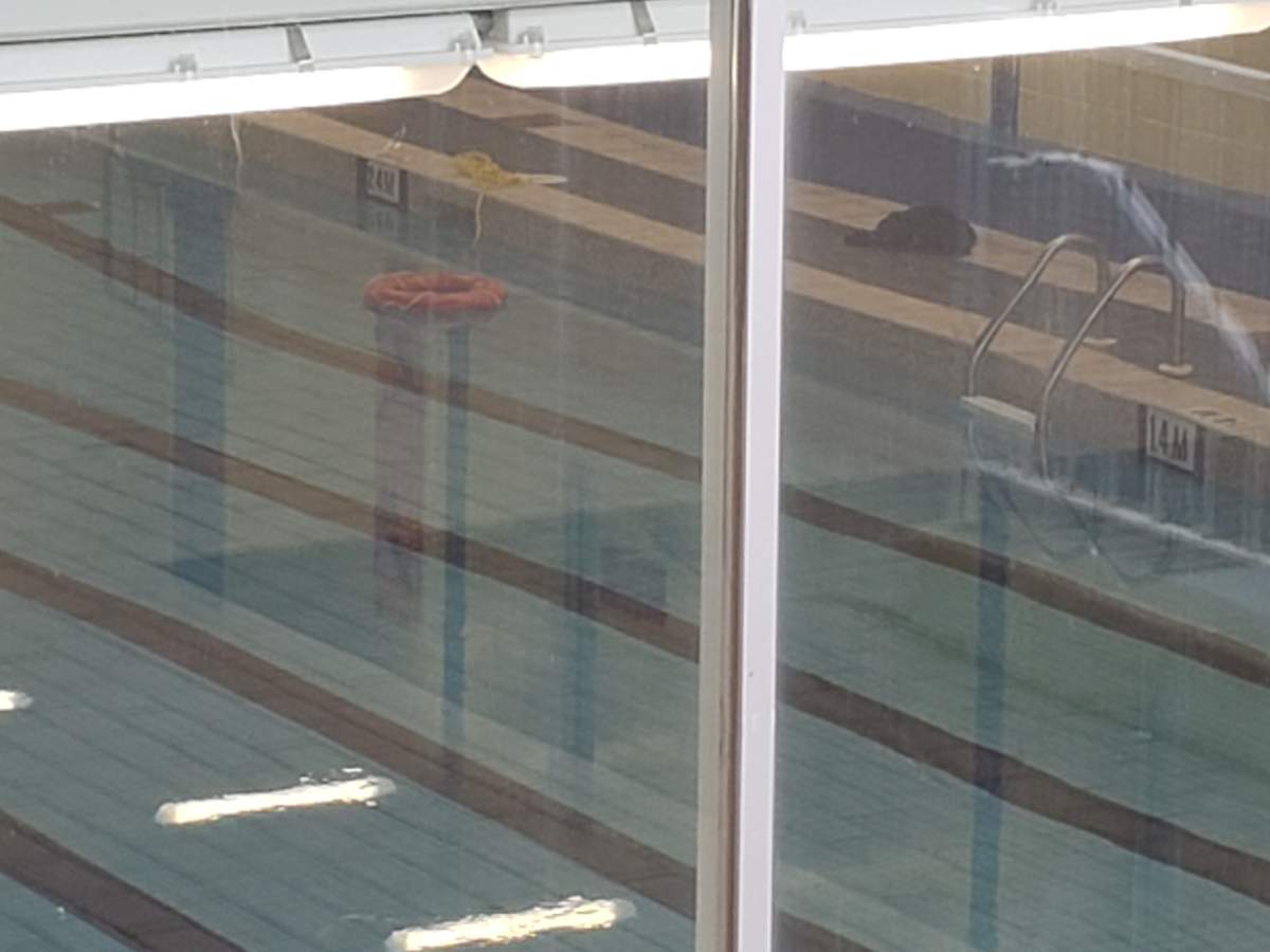A life preserver floats in the empty Courts of St. James pool in Winnipeg. There was a heavy police presence at the facility on Sunday evening.