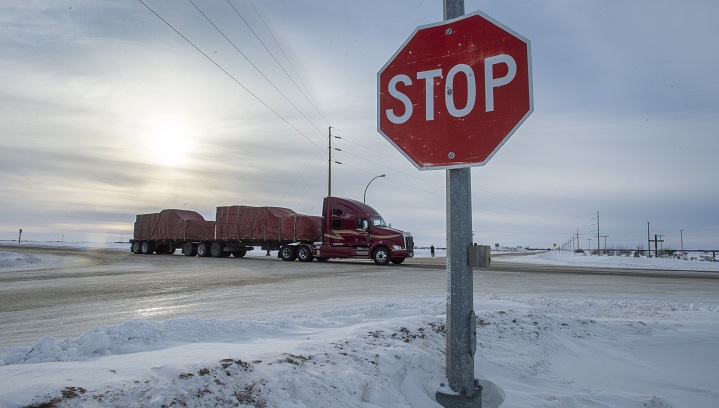 A truck goes through the intersection near the memorial for the 2018 crash where 16 people died and 13 injured when a truck collided with the Humboldt Broncos hockey team bus, at the crash site on Jan. 30, 2019 in Tisdale, Sask.