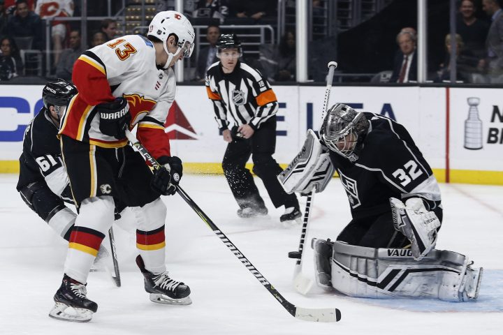 Los Angeles Kings goalie Jonathan Quick (32) blocks a shot by Calgary Flames forward Johnny Gaudreau (13) during the first period of an NHL hockey game Monday, April 1, 2019, in Los Angeles. 