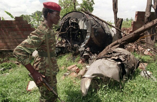 In this May 23, 1994, file photo, a Rwandan Patriotic Front (RPF) rebel walks by the plane wreckage in which Rwanda’s President Juvenal Habyarimana died April 6, 1994, in Kigali, Rwanda.