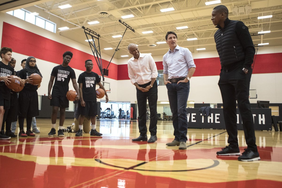 Prime Minister Justin Trudeau, centre, and Minister of Immigration, Refugees and Citizenship Ahmed Hussen, centre left, attend a basketball clinic with local youth, hosted by President of the Toronto Raptors Masai Ujiri, right, in Toronto on Saturday, April 6, 2019. 