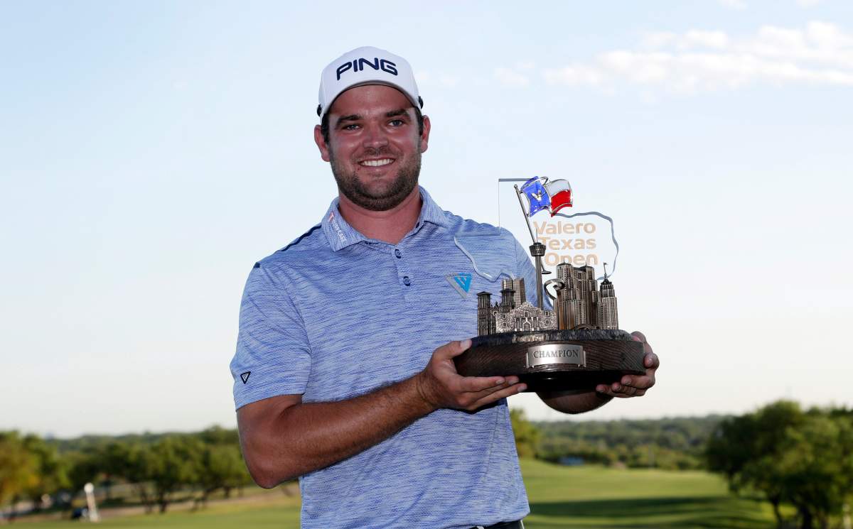 Corey Conners poses with the trophy after winning the Valero Texas Open golf tournament Sunday, April 7, 2019, in San Antonio.