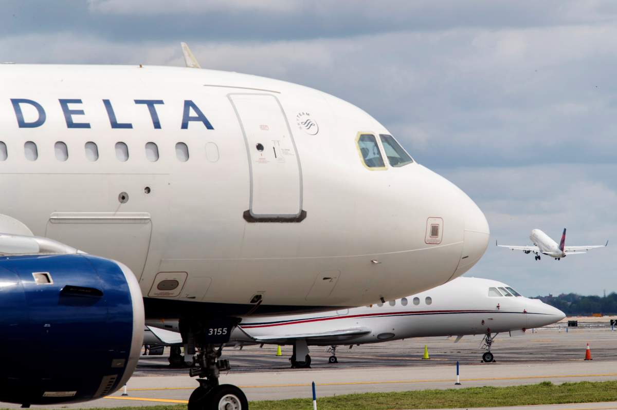 FILE - In this Aug. 8, 2017, file photo, a Delta Air Lines jet waits on the tarmac at LaGuardia Airport in New York.