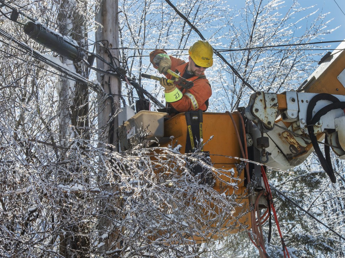 Hydro-Quebec workers repair power lines in Laval, Que., Wednesday, April 10, 2019, after an ice storm hit the area. Thousands of homes and businesses are still without power.