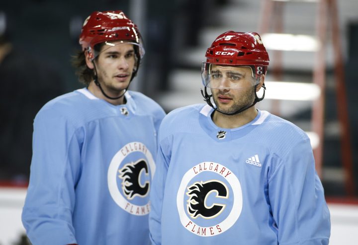 Calgary Flames’ Mark Giordano, right, and Sean Monahan look on during practice in Calgary, Tuesday, April 9, 2019.