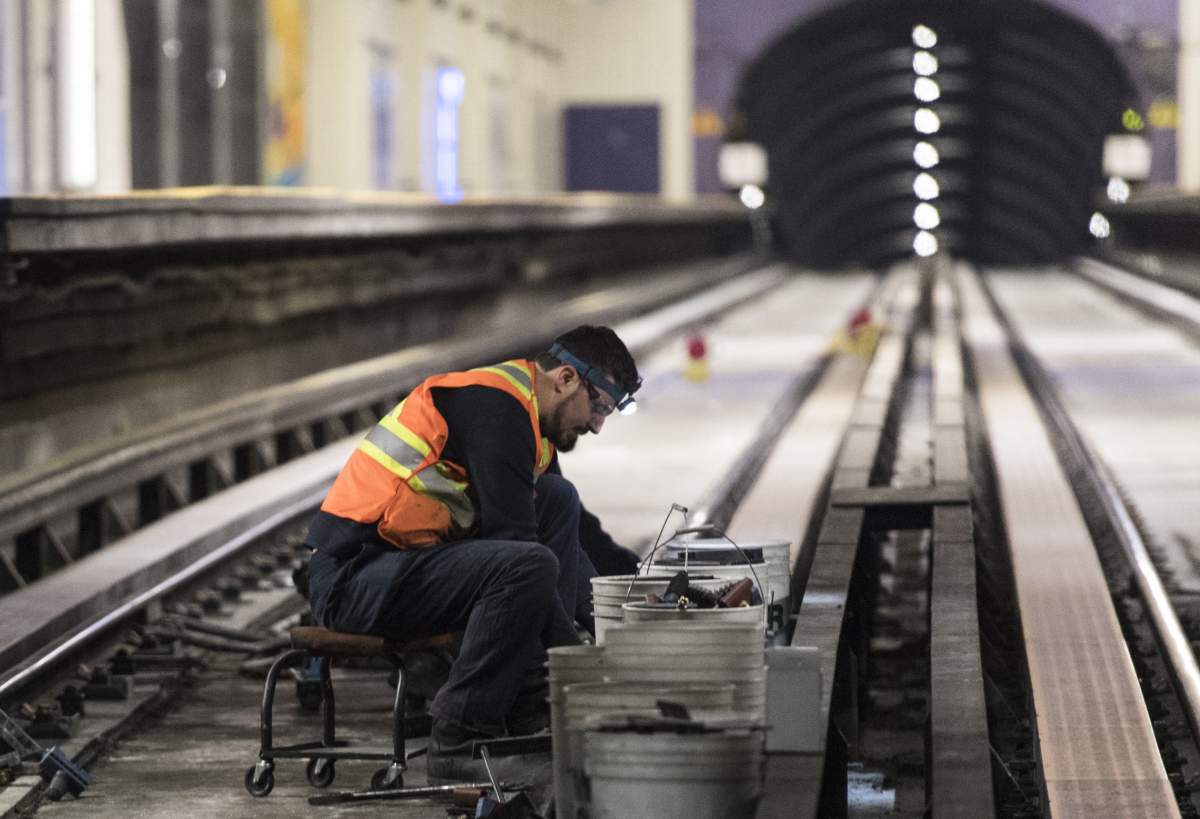 A Montreal Metro maintenance crew work on a track during the early hours of the morning in Montreal, Thursday, April 11, 2019. 