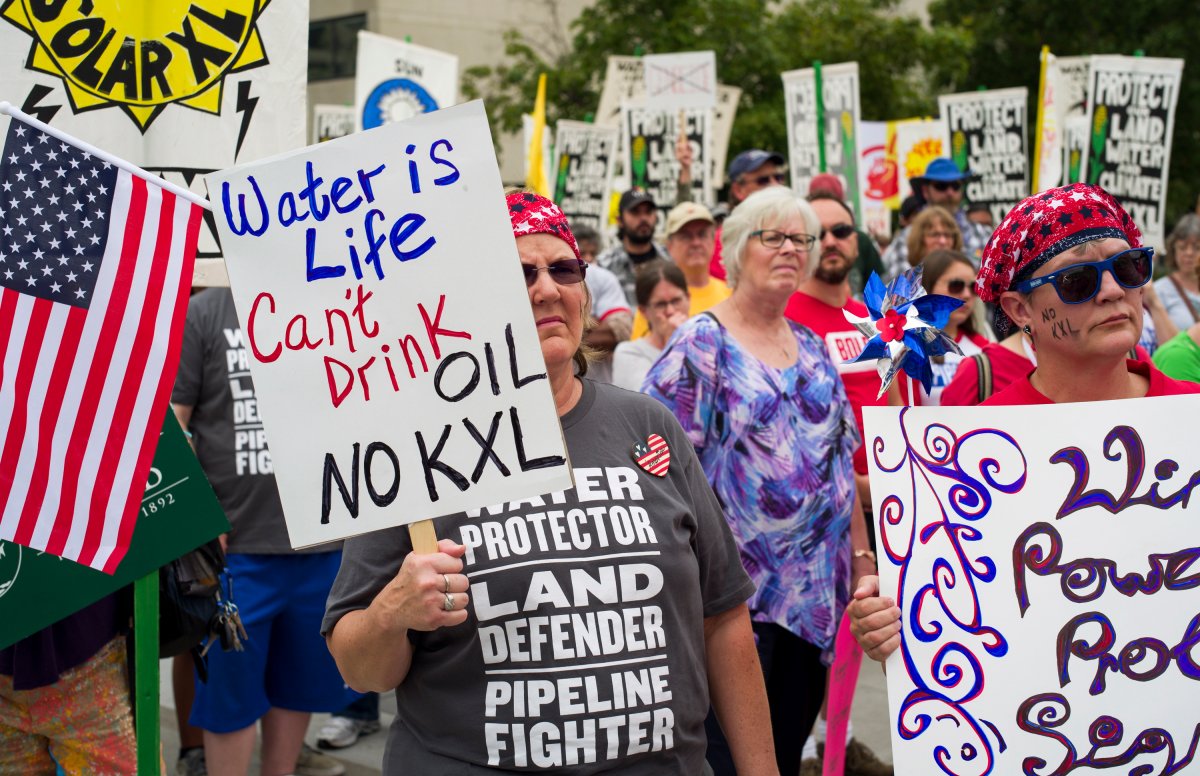 FILE - In this Aug. 6, 2017 file photo, demonstrators against the Keystone XL pipeline listen to speakers in Lincoln, Neb.