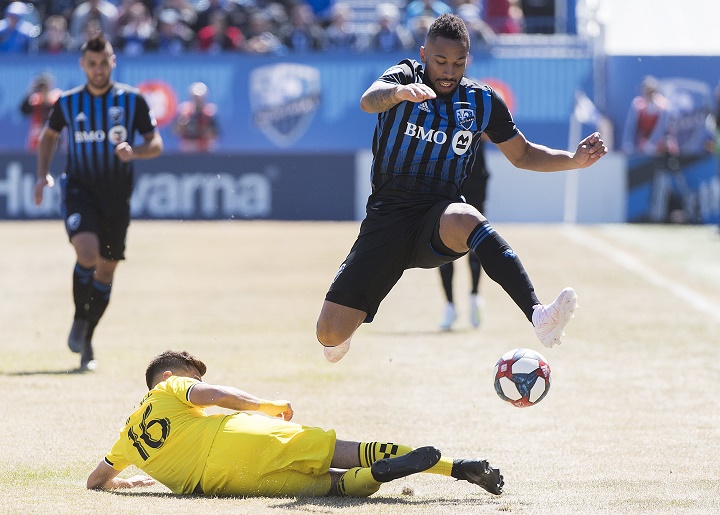 Montreal Impact's Harry Novillo, right, leaps over Columbus Crew SC's Hector Jimenez during first half MLS soccer action in Montreal, Saturday, April 13, 2019. 