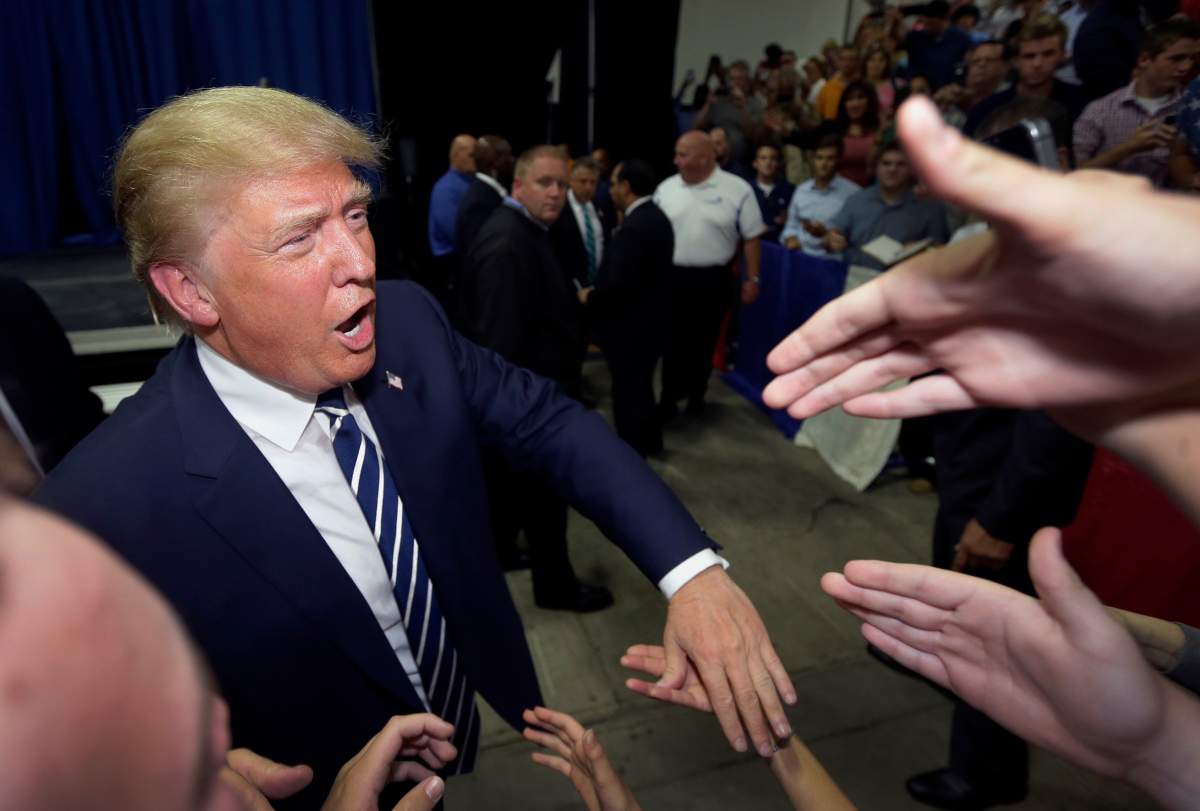 FILE - In this Aug. 11, 2015, file photo, Republican presidential candidate Donald Trump meets supporters after addressing a GOP fundraising event in Birch Run, Mich.