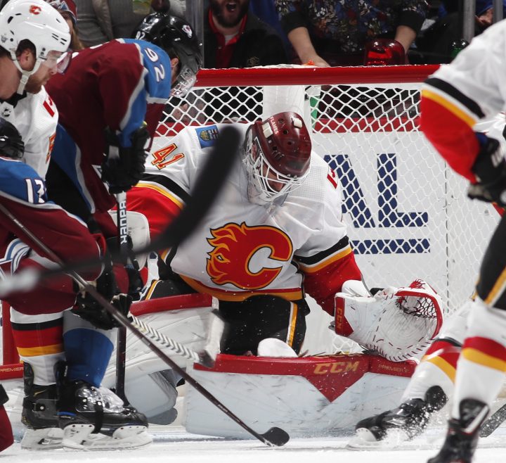 Calgary Flames goaltender Mike Smith, right, makes a stop of a shot by Colorado Avalanche left wing Gabriel Landeskog in the second period of Game 3 of a first-round NHL hockey playoff series, Monday, April 15, 2019, in Denver.