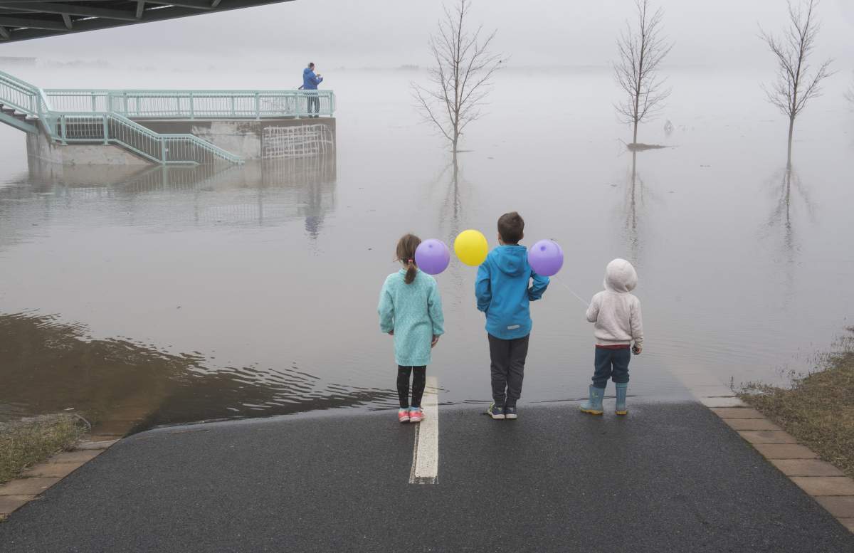Children look over the flooding of the St. John River in Fredericton on Sunday, April 21, 2019.