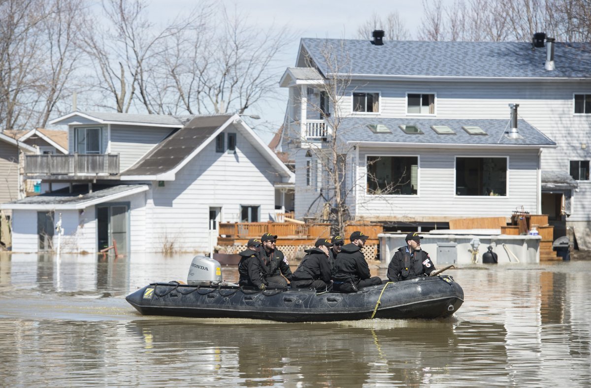 Members of the Naval Reserve patrol the Rigaud River next to homes surrounded by floodwaters in the town of Rigaud, Que, west of Montreal, Monday, April 22, 2019. 