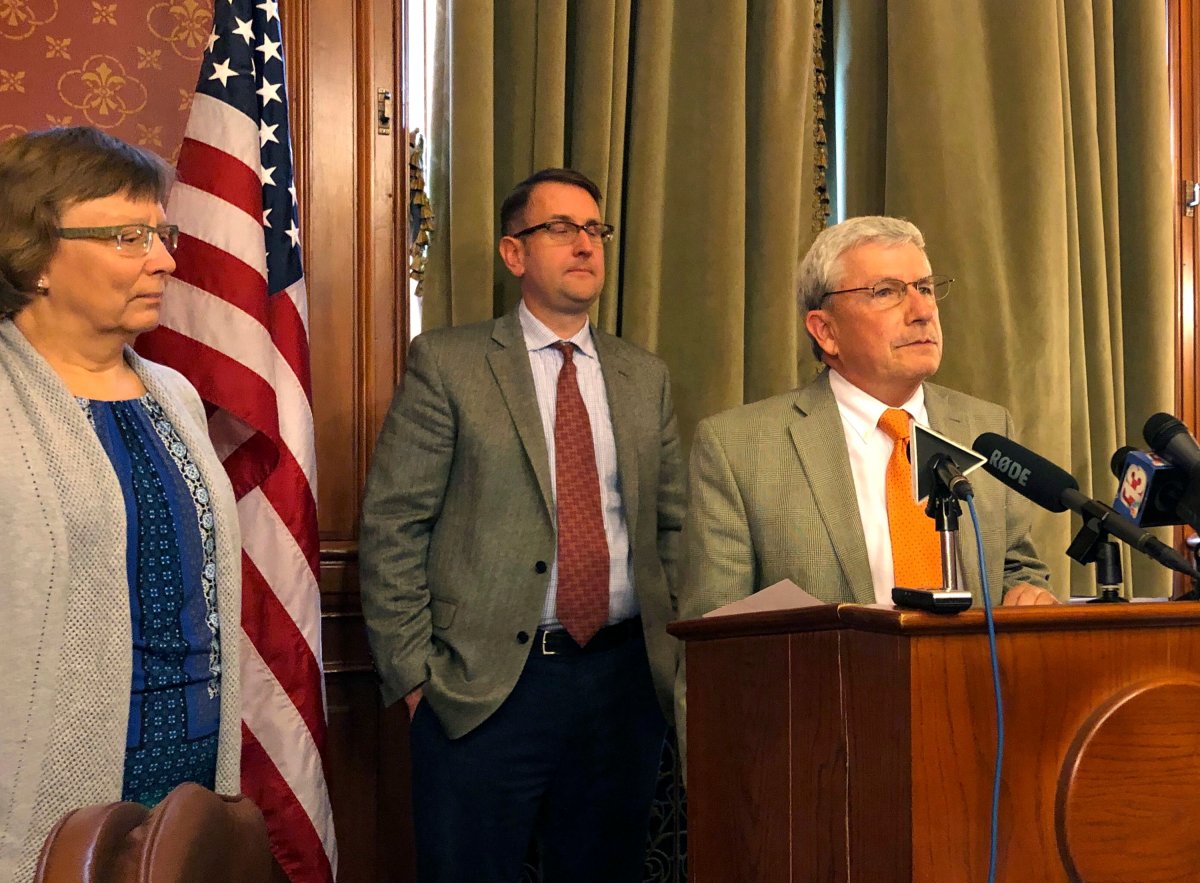 Iowa Rep. Andy McKean, right, the longest serving Republican in the Iowa Legislature says he's becoming a Democrat during a news conference at the Statehouse in Des Moines, Tuesday, April 23, 2019. 