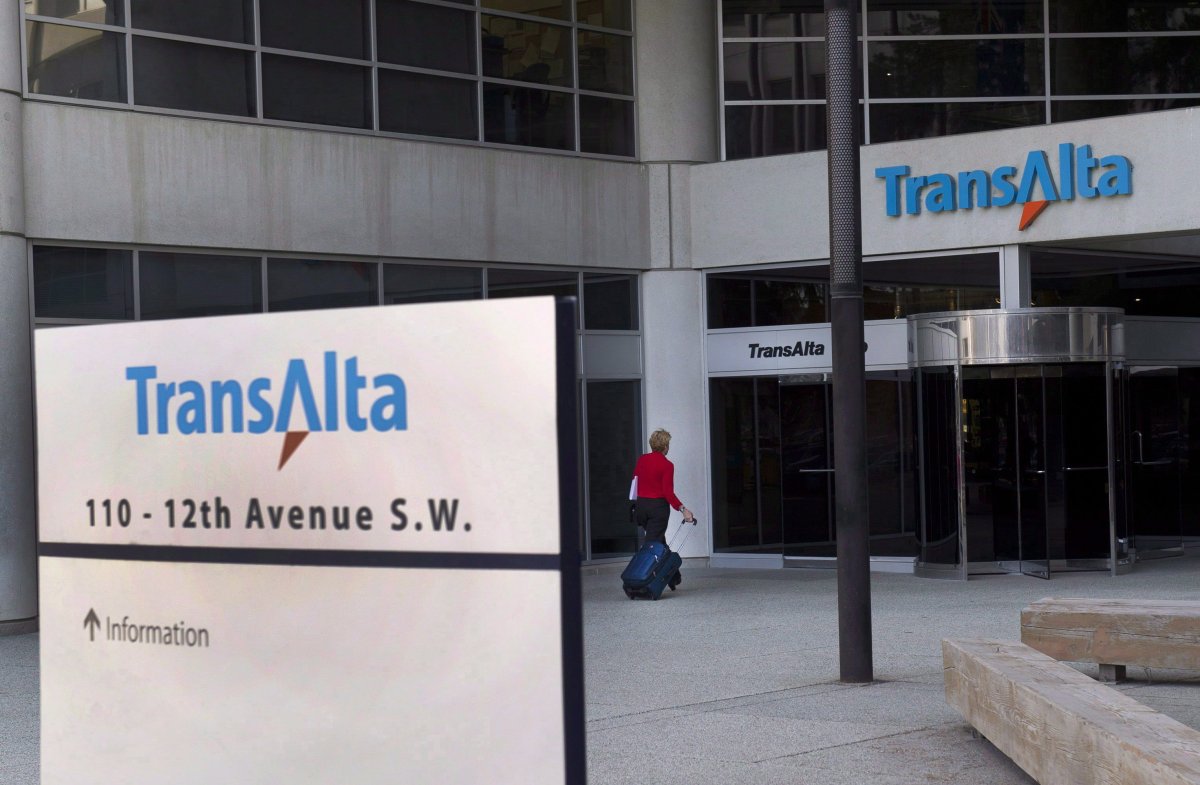 A woman walks towards the entrance of the TransAlta headquarters building in Calgary, on Tuesday, April 29, 2014. 