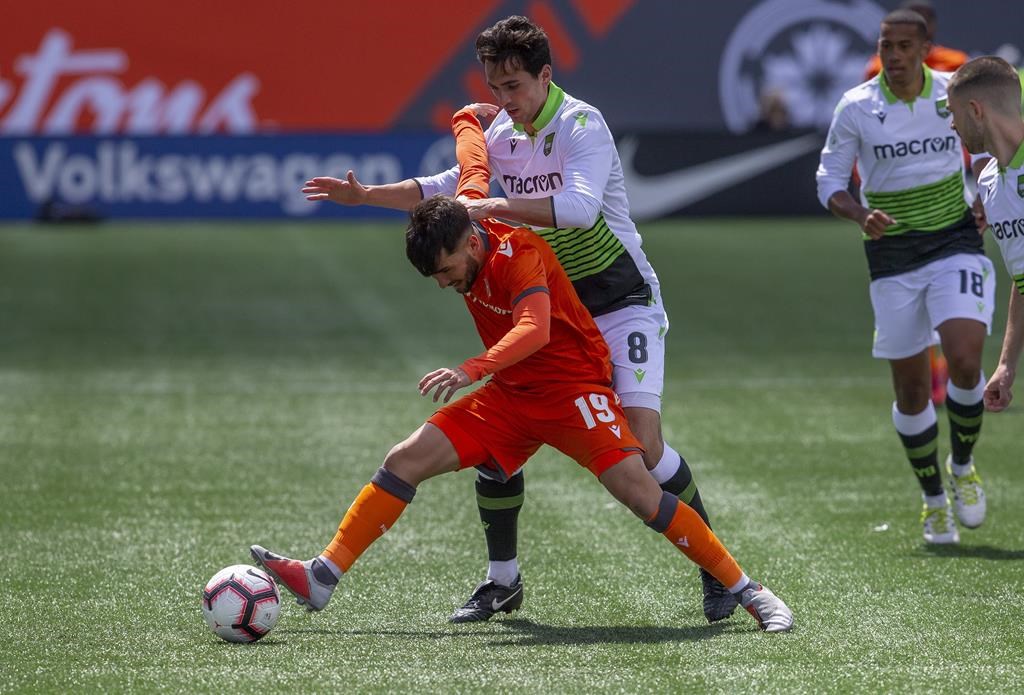 Forge FC midfielder Tristan Borges, left, defends the ball from York 9 midfielder Joseph Di Chiara during the inaugural soccer match of the Canadian Premier League between Forge FC of Hamilton and York 9 in Hamilton, Ont.,.