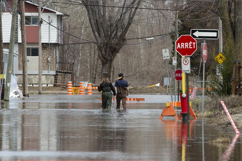 Local residents make their way through flood waters in Gatineau, Que., Tuesday, April 23, 2019.