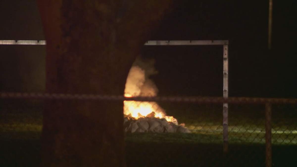 Police dispose of old explosives in a park on Victoria Drive on Thursday night.
