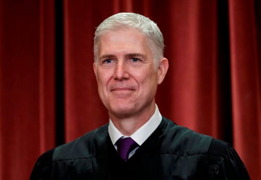 In this Nov. 30, 2018 file photo, Associate Justice Neil Gorsuch, appointed by President Donald Trump, sits with fellow Supreme Court justices for a group portrait at the Supreme Court Building in Washington.