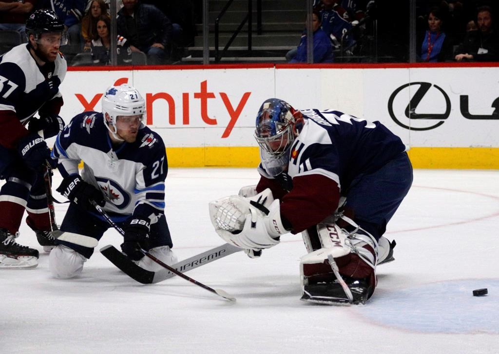 Winnipeg Jets left wing Nikolaj Ehlers (27) scores on Colorado Avalanche goaltender Philipp Grubauer (31) during the first period of an NHL hockey game in Denver, Thursday, April 4, 2019. (AP Photo/Joe Mahoney)