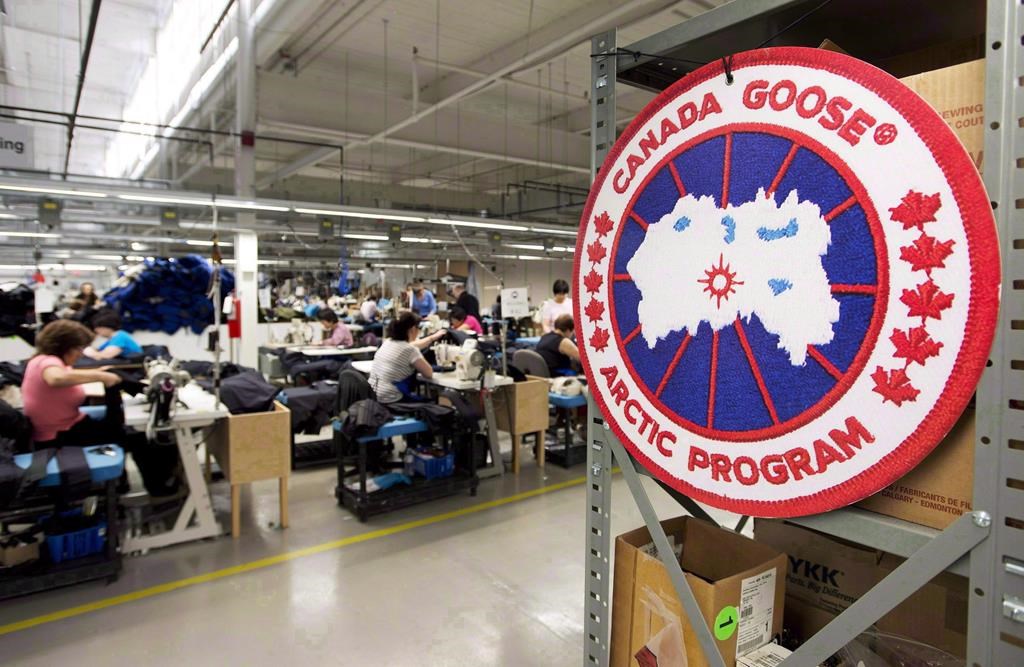 Employees work with Canada Goose jackets at the Canada Goose factory in Toronto on Thursday, April 2, 2015.