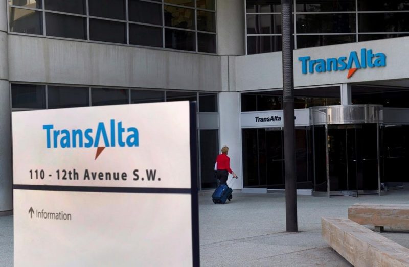 A woman walks towards the entrance of the TransAlta headquarters building in Calgary on April 29, 2014.