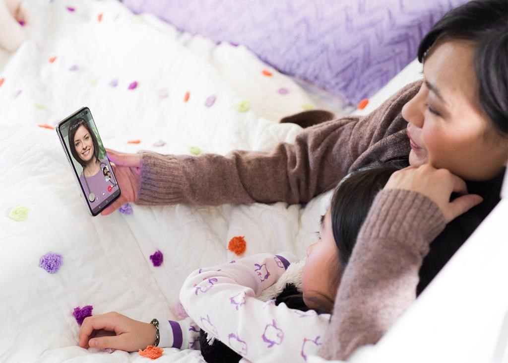 A mother and daughter use the Babylon by Telus Health app in this undated handout photo.