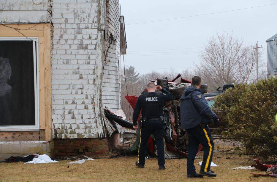 Police officers respond to the crash in Centreville, N.S., on Saturday, April 13, 2019.