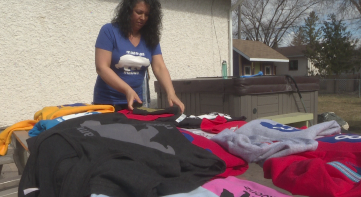 Kim Blackburde-Moore organizing her stock of T-shirts and hoodies.