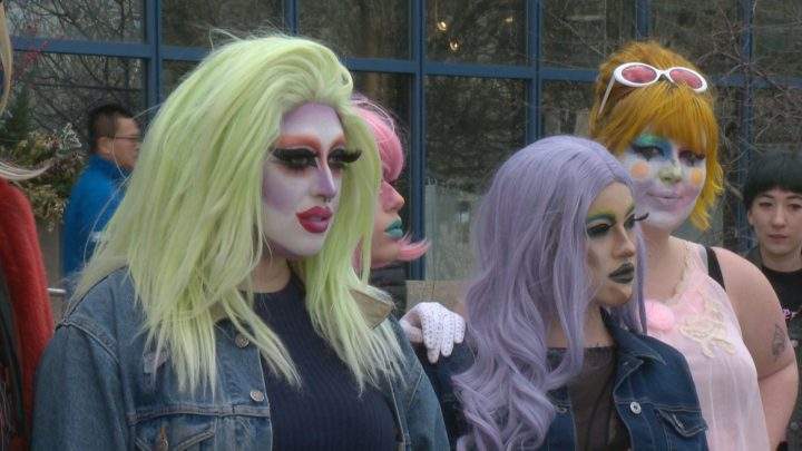 Calgary drag queens, including Vanta Blaque with the green hair, strutted to city hall to participate in advance Alberta election polls on Wednesday.