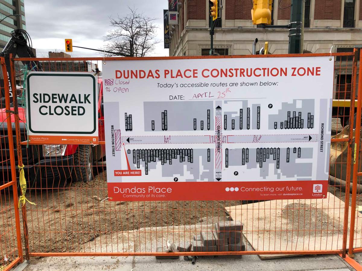 This sign, updated daily, provides pedestrians with a guide to where sidewalks are available throughout the Dundas Place construction zone.