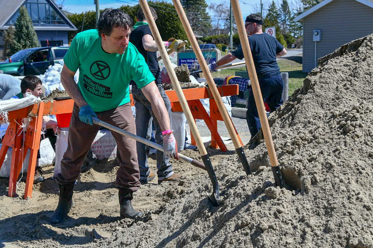Volunteers in Britannia fill sandbags to combat rising water levels in the Ottawa river. The city continues the call for volunteers offering a modified schedule for those who wish to help.