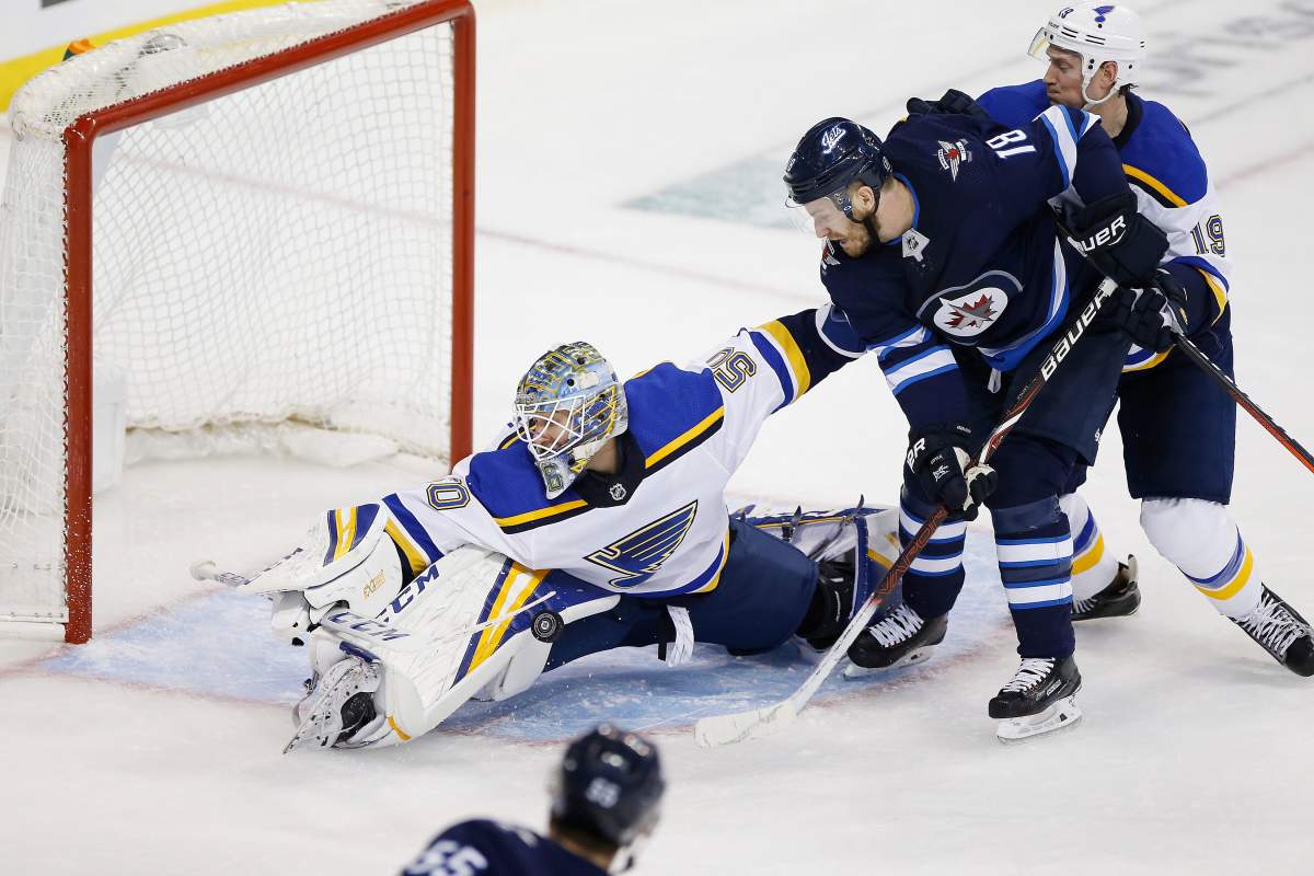 St. Louis Blues goaltender Jordan Binnington (50) stops the shot from Winnipeg Jets' Mark Scheifele (55) in the late seconds of third period NHL playoff action in Winnipeg on Wednesday, April 10, 2019. THE CANADIAN PRESS/John Woods.